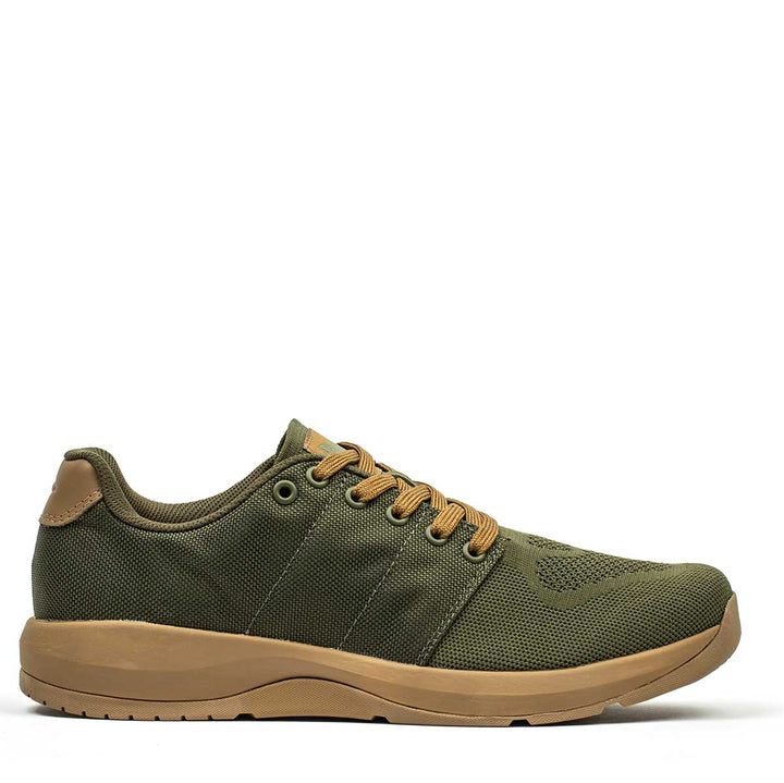 The GORUCK Ballistic Trainers - Green + Gum athletic shoe is made from durable CORDURA® Ballistic Nylon, showcasing a tan sole and laces. Designed for functional fitness enthusiasts, it provides 3X Stability and an elegant side view.