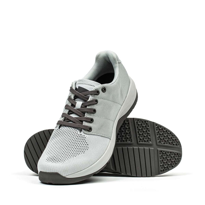 The GORUCK Ballistic Trainers in Lunar Rock and Charcoal are crafted from durable CORDURA Ballistic Nylon, featuring black soles and laces, and are displayed against a white background. Perfect for functional fitness footwear, they offer 3X Support for enhanced performance.