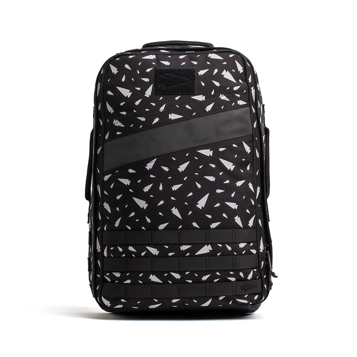 The GORUCK Rucker 4.0 backpack boasts a bold white geometric pattern complemented by a front diagonal black stripe, making it ideal for both rucking adventures and daily use.