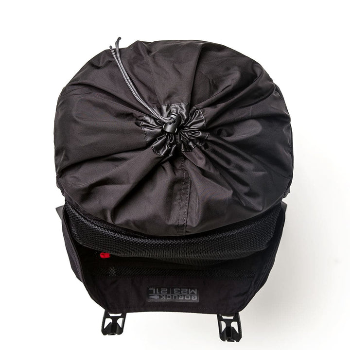 Top view of a GORUCK M23 - Cordura rucksack with a closed top. This contemporary rucksack showcases mesh pockets and adjustable straps, constructed from robust materials for a minimalist, stylish design.