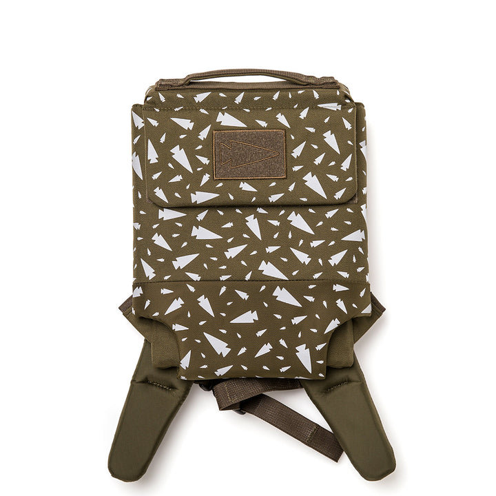 The GORUCK Ruck Plate Carrier 3.0 is a green backpack featuring a geometric pattern of scattered white triangles, adjustable straps, and a padded top handle for added convenience.