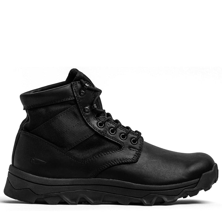 The MACV-2 - Mid Top - Black by GORUCK is a black lace-up combat boot with a sturdy triple compound outsole, combining leather and fabric materials. It features metal eyelets and a reinforced ankle collar for a rugged and durable look against a white background.