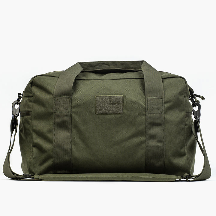 The GORUCK Kit Bag, showcased against a white background, is an olive green duffel resembling an Aviator's Kit Bag with a durable shoulder strap and handles.