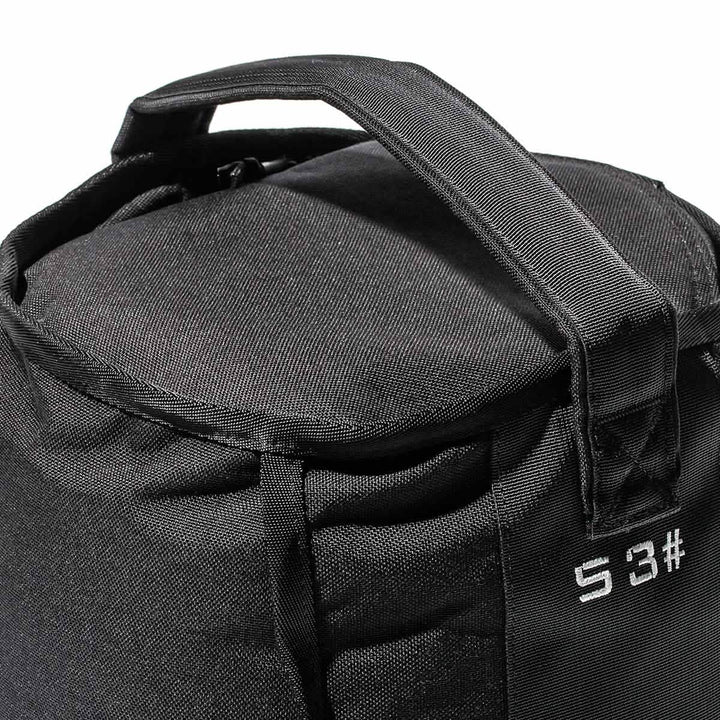 Close-up of a GORUCK Sand Kettlebell - 53LB (24KG), a black fabric bag with two handles and white text "S3" on the side, crafted for endurance and perfect for portable kettlebell workouts.