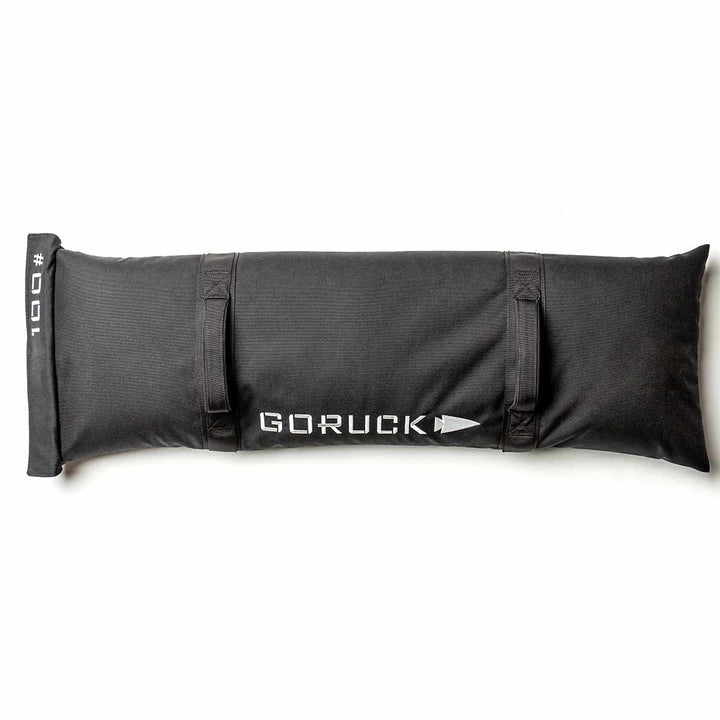 The Simple Training Sandbags by GORUCK feature a sleek black design with the iconic "GORUCK" logo and adjustable straps, set against a white background. Ideal for versatile home gym setups, these sandbags are crafted to endure intense workouts and come with the esteemed Scars Lifetime Guarantee.