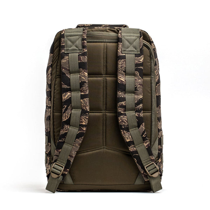 Back view of the rugged GR1 USA rucksack by GORUCK, showcasing a camouflage design, made from durable 210D CORDURA fabric. It includes padded straps and a quilted back panel.