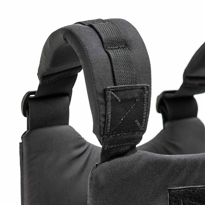 Close-up of the black padded straps on the GORUCK Training Weight Vest, highlighting its meticulous stitching and sturdy buckles.